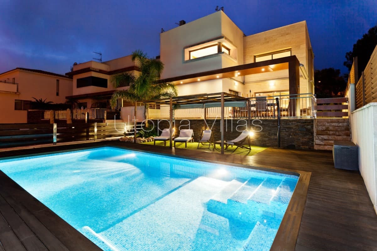 Villa Claudia and its beautiful swimming pool illuminated at night, Sitges, Barcelona