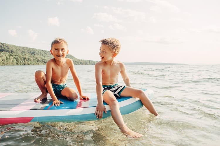 Dos niños felices en un SUP