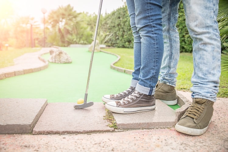 Two people playing mini golf in Sitges