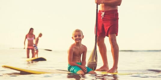 Family stand up paddling at sunrise, Summer fun outdoor lifestyle