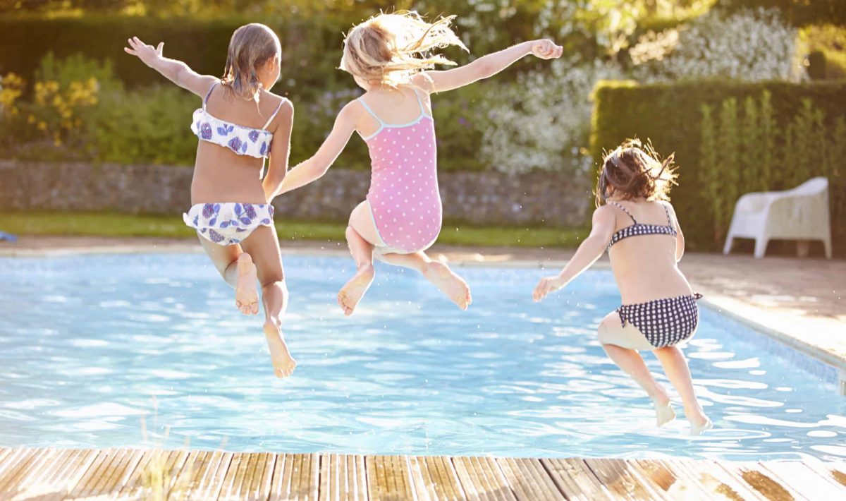 Children jumping into a pool at a Family Villa